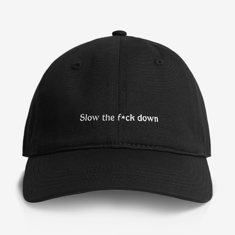 Black cap with slow the f*ck down embroidery on the front